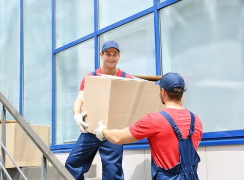 Professional team handling bulky furniture collection in Manorhouse