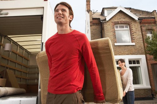 Trained movers handling furniture with care during a Manorhouse relocation