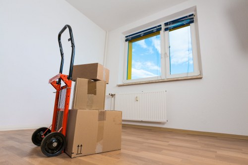 Professional movers handling furniture during a same day removal in a North London flat