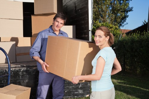 Movers managing stair access during a flat relocation in Manorhouse