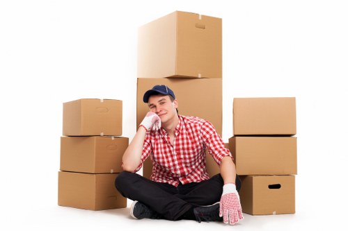 Packed boxes and workplace items ready for transport during a Manor House business move