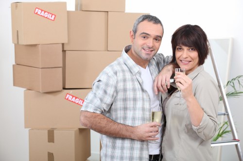 Professional movers handling desks and equipment for an office move in Manor House